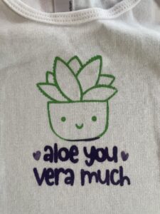 Cheesy baby shirt that says "Aloe you vera much" with a picture of an alow plant