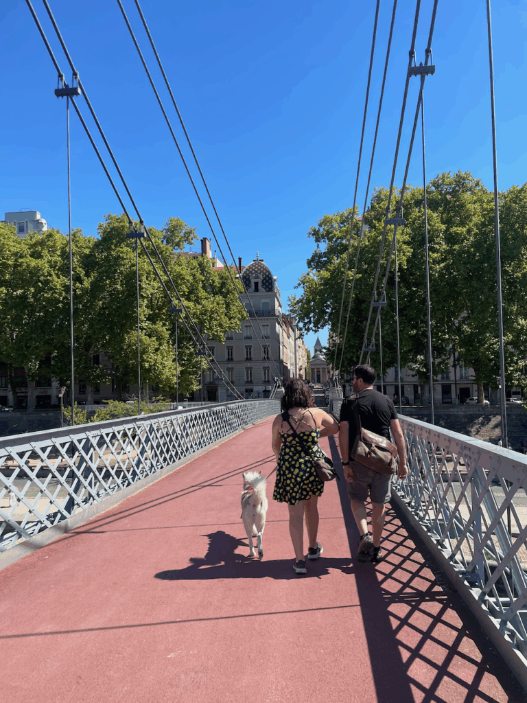 Kristian, Lilian, and Lumi walk across one of Lyon's many bridges