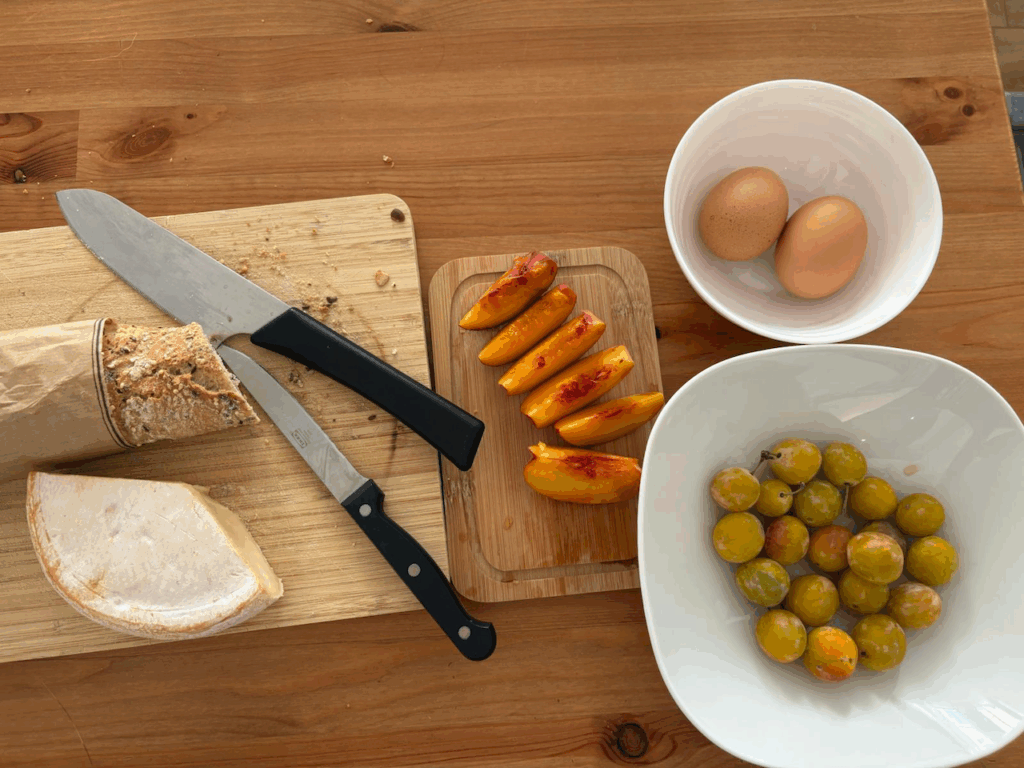hard boiled eggs, mirabelles, peaches, bread, cheese