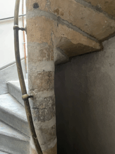 a steep staircase with a nearly vertical railing