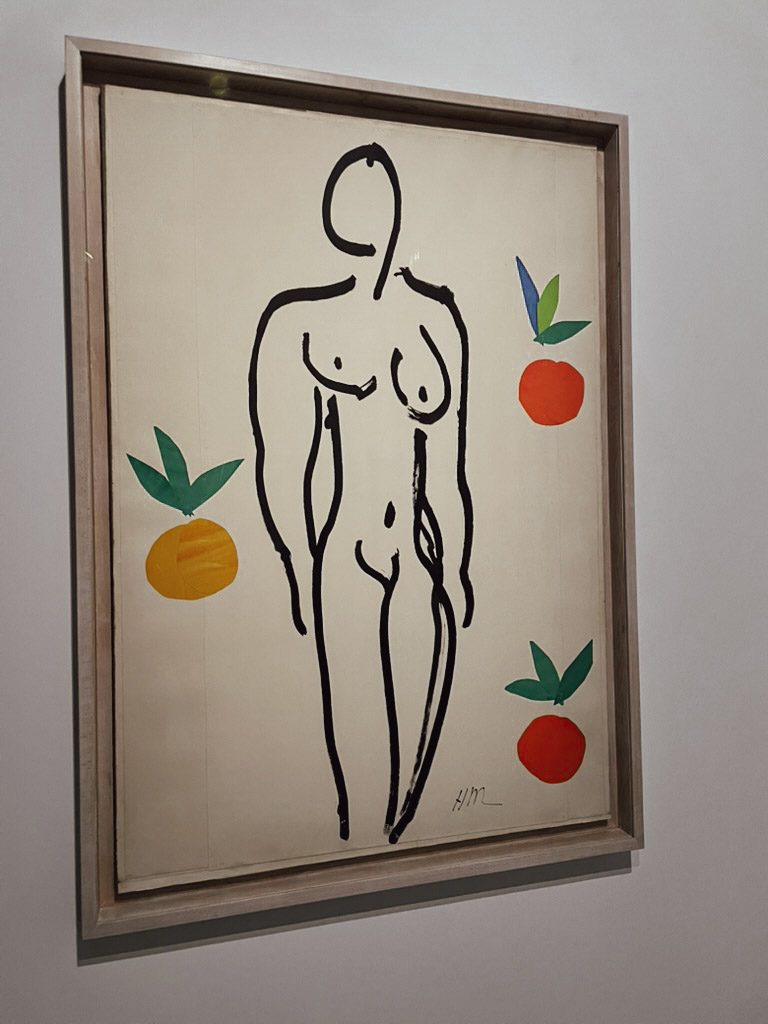 A minimalist illustration of a nude figure with bold black lines, surrounded by colorful orange and green shapes. The artwork reflects the style of Henri Matisse.