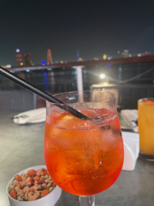 aperol spritz with river in the background