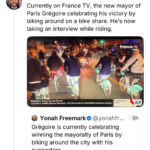 The new mayor of Paris, Grégoire, celebrates his election victory by biking through the city with supporters at night, while being interviewed. Bright lights and a festive atmosphere surround the group.